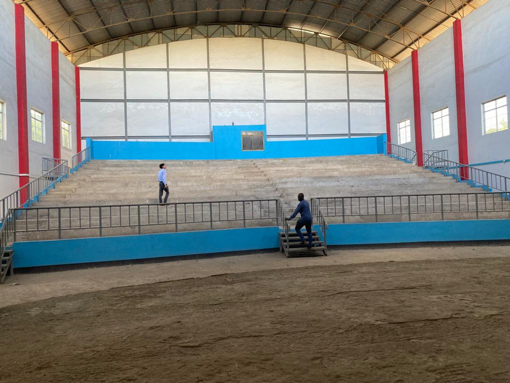 An empty concert hall with two people inspecting the audience stand.